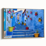 Framed canvas featuring a vintage-style Moroccan landscape with colorful art and black accents, ideal for living room decor.