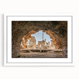 Abstract art print of Tunisian scenery in muted earth tones on a white framed canvas, suitable for dining room decor.