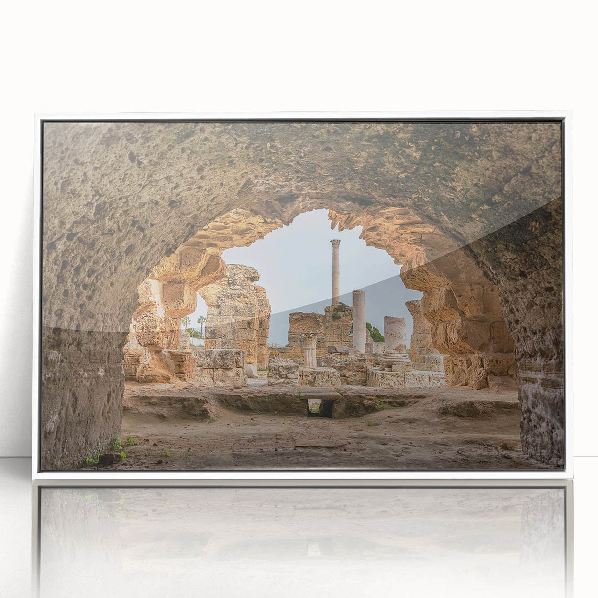 Art deco poster of a Tunisian landscape in muted earth tones, framed in white acrylic, ideal for modern art wall decor.