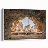 Vintage poster art of a Tunisian landscape on framed canvas, featuring muted earth tones, ideal for living room decor.