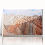 Art deco poster of an Asian landscape on white acrylic, framed, in muted earth tones.