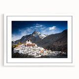 Abstract art print of a Tibetan landscape in muted earth tones on a framed white mat, suitable for dining room decor.