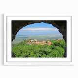 Abstract art print featuring a geometric design in muted earth tones on a white framed canvas.