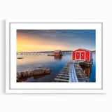 Abstract art print of Newfoundland scenery in muted blue and green tones, framed with a white mat.