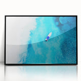 Large abstract wall art depicting a Caribbean scenery in vibrant blue and green tones, framed in black acrylic.