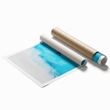 Extra large rolled print of a Caribbean beach scene with soft blue and white hues, ideal for classy bathroom wall art.
