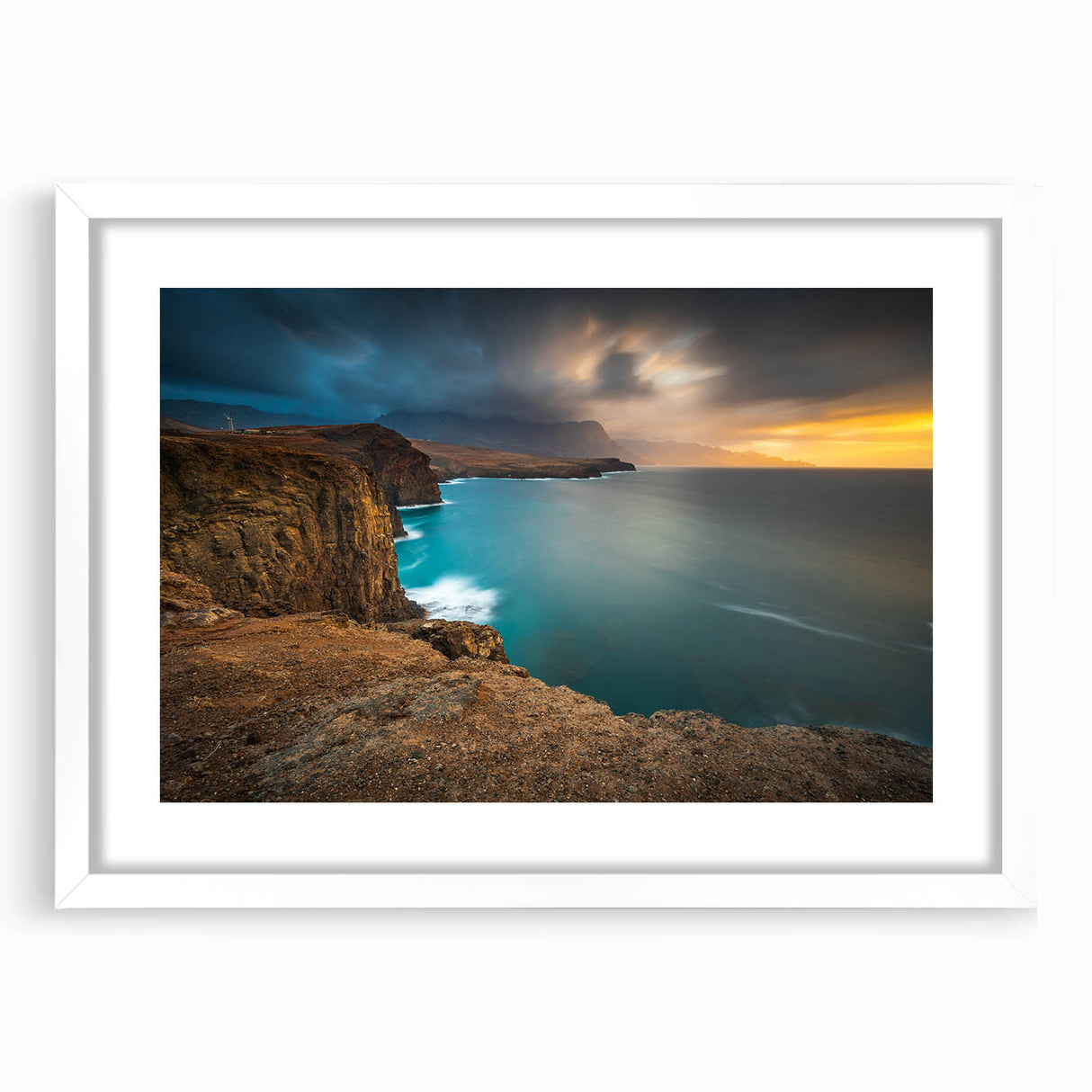 Textured abstract art print of a Caribbean scene in muted blues and greens, framed with a white mat.