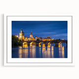 Textured art depicting an abstract European cityscape in muted blue and gray tones, framed with a white mat.