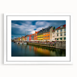 Abstract art print depicting a serene European landscape in muted blue and green tones on a framed white mat.