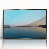 Large acrylic print of a serene Finnish landscape in muted blues and greens, framed in silver.