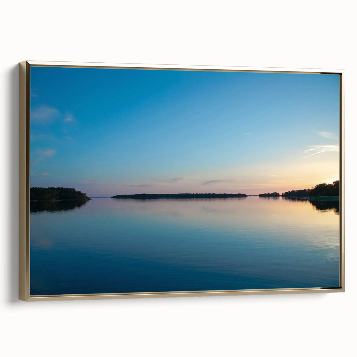 Framed canvas featuring a vintage-style landscape painting of a serene Finnish scenery in muted gold and black tones.