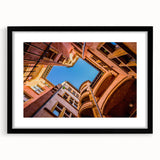 Extra large abstract art print of Lyon scenery in colorful, textured style on a black framed canvas.