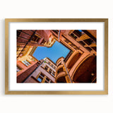 Abstract art print of Lyon scenery in muted gold and blue tones, framed with a mat.