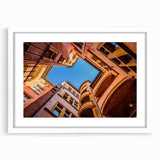 Textured abstract art print of Lyon scenery in muted earth tones, framed with a white mat, ideal for bedroom art.