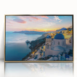 Acrylic print of Santorini landscape featuring white buildings and blue domes, in pastel shades, framed in gold.