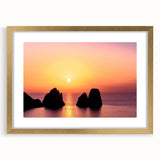 Abstract art print of Capri, Italy in muted blue and gold tones, framed with a gold mat, suitable for dining room decor.