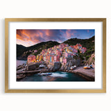 Abstract art print of Cinque Terre with vibrant coastal hues on a gold-framed mat, ideal for dining room decor.