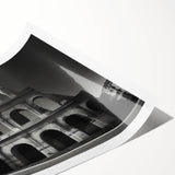 Extra large wall art featuring a line art depiction of the Colosseum in Italy, rendered in black on a white rolled print.
