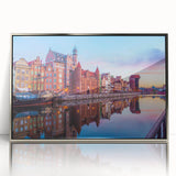 Mid-century modernist style large art print of a European cityscape in muted colors, framed in silver acrylic.