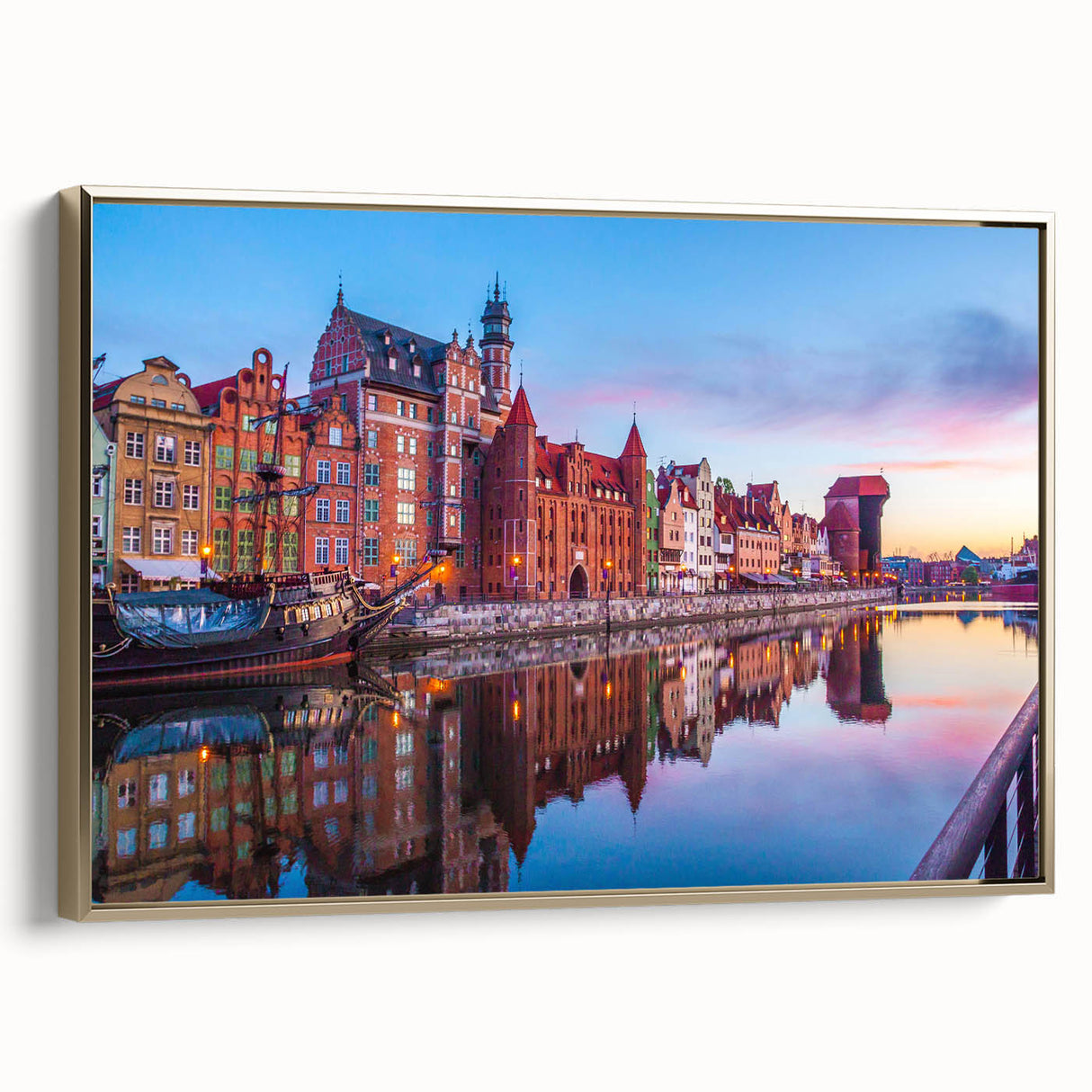 Framed canvas featuring a vintage-style landscape painting of a European scene in black and gold tones.