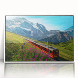 Acrylic print of a serene Swiss landscape with lush greenery and mountains, in a white frame.