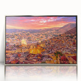 Mid-century modernist art depicting the colorful buildings of Guanajuato, Mexico, in a silver-framed acrylic print.