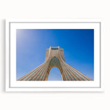 Abstract art print of a Middle Eastern landscape in earth tones on a white framed mat, ideal for dining room decor.