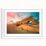 Abstract art print of a Middle Eastern landscape in muted earth tones on a white matted frame.