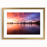 Extra large abstract art print of Auckland skyline in textured shades of blue and gray on a gold-framed canvas.