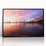 Large abstract wall art depicting Auckland's skyline in muted gray and blue tones, framed in black acrylic.