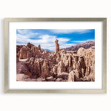 Textured abstract art print of a Bolivian landscape in muted earth tones, framed in silver, suitable for bedroom decor.