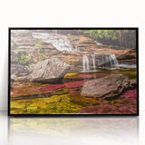 Acrylic print of a large abstract wall art depicting a colorful Colombian landscape, framed in black.