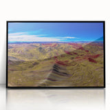 Large abstract wall art depicting a stylized South American landscape in muted earth tones, framed in black acrylic.