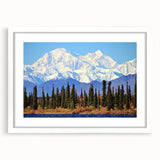 Abstract art print of an Alaskan landscape in muted blue and gray tones, framed in white, suitable for dining room decor.