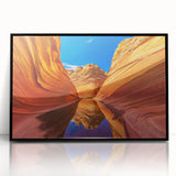Large abstract wall art of Coyote Buttes in Arizona, featuring earthy red and orange tones on a black framed acrylic.