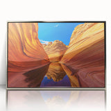 Mid-century modernist art depicting the Coyote Buttes in Arizona with muted earth tones on a silver-framed acrylic print.