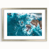 Textured art of Big Sur coastline in muted blue and gray tones on a framed silver mat, ideal for bedroom ambiance.