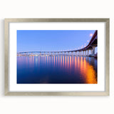 Textured abstract art print of San Diego scenery in muted blue and gray tones on a framed silver mat.