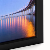 Close-up of a textured, extra-large framed canvas depicting San Diego scenery in black with colorful accents.