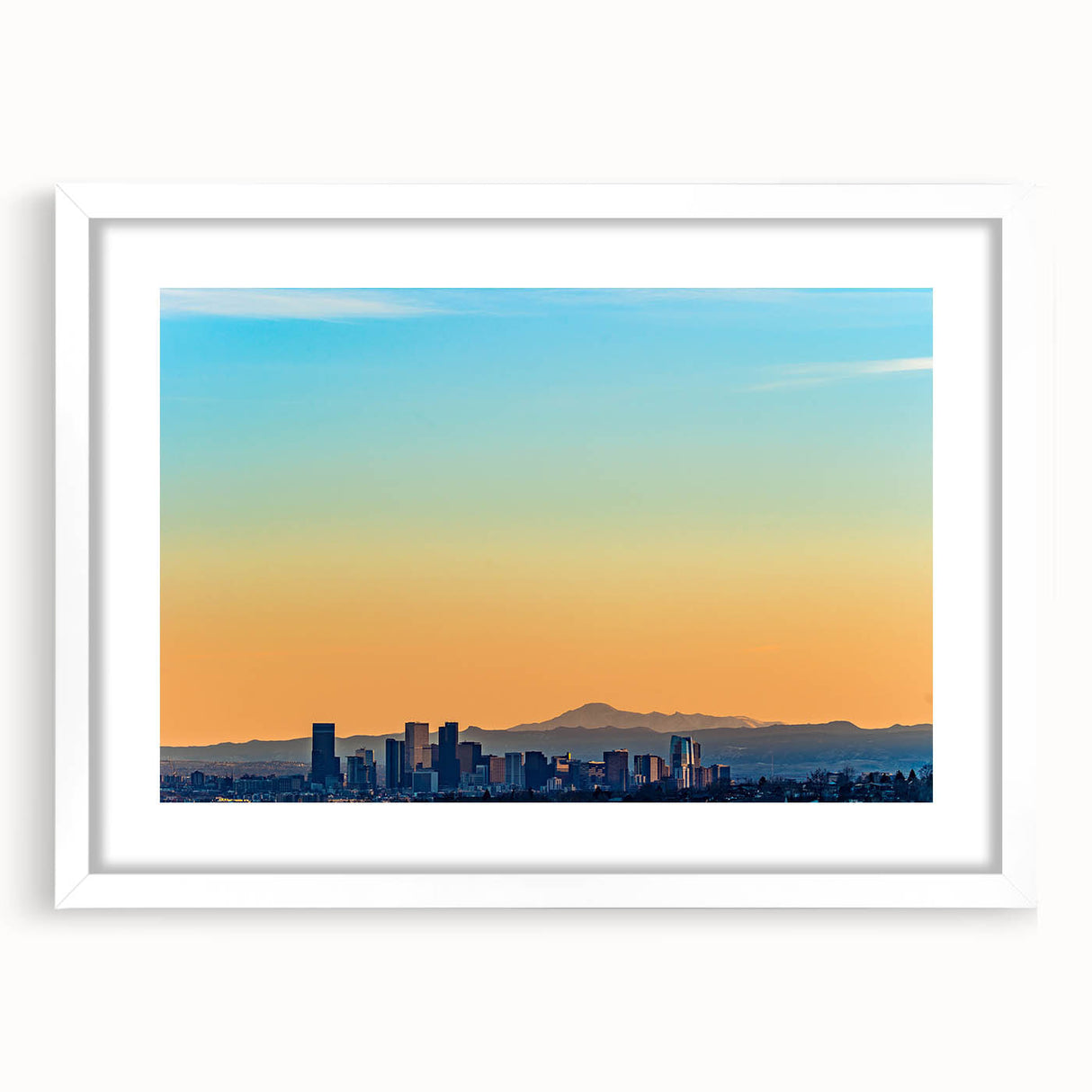 Abstract art print of Denver skyline in muted blue tones on a framed white mat, ideal for dining room decor.