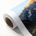 Rolled canvas depicting the Rocky Mountains in muted earth tones, suitable as nursery wall art or in a dining room.