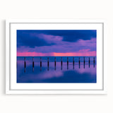 Abstract art print of Florida Keys in muted blue and green tones on a framed white mat, suitable for dining room decor.