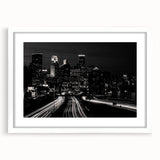 Abstract art print of Minneapolis skyline in muted blue and gray tones on a framed white mat, suitable for dining room decor.
