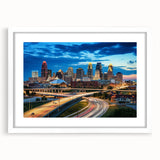 Abstract art print of Kansas City skyline in muted blue and gray tones on a framed white mat, ideal for dining room decor.