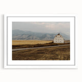 Abstract art print of Montana scenery in muted earth tones on a framed white mat, suitable for bedroom or dining room decor.