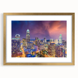Extra large abstract art print of Charlotte skyline in muted earth tones on a textured canvas, framed in gold.
