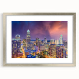 Textured abstract art print of Charlotte skyline in muted gray and silver tones, framed with a silver mat.