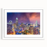 Abstract art print of the Charlotte skyline in muted blue and gray tones, framed with a white mat.
