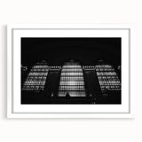 Abstract art print of New York City's Grand Central, in muted gray and blue tones, framed with white mat.