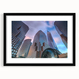 Abstract art print of Manhattan skyline in muted gray and blue tones, framed with a black mat.